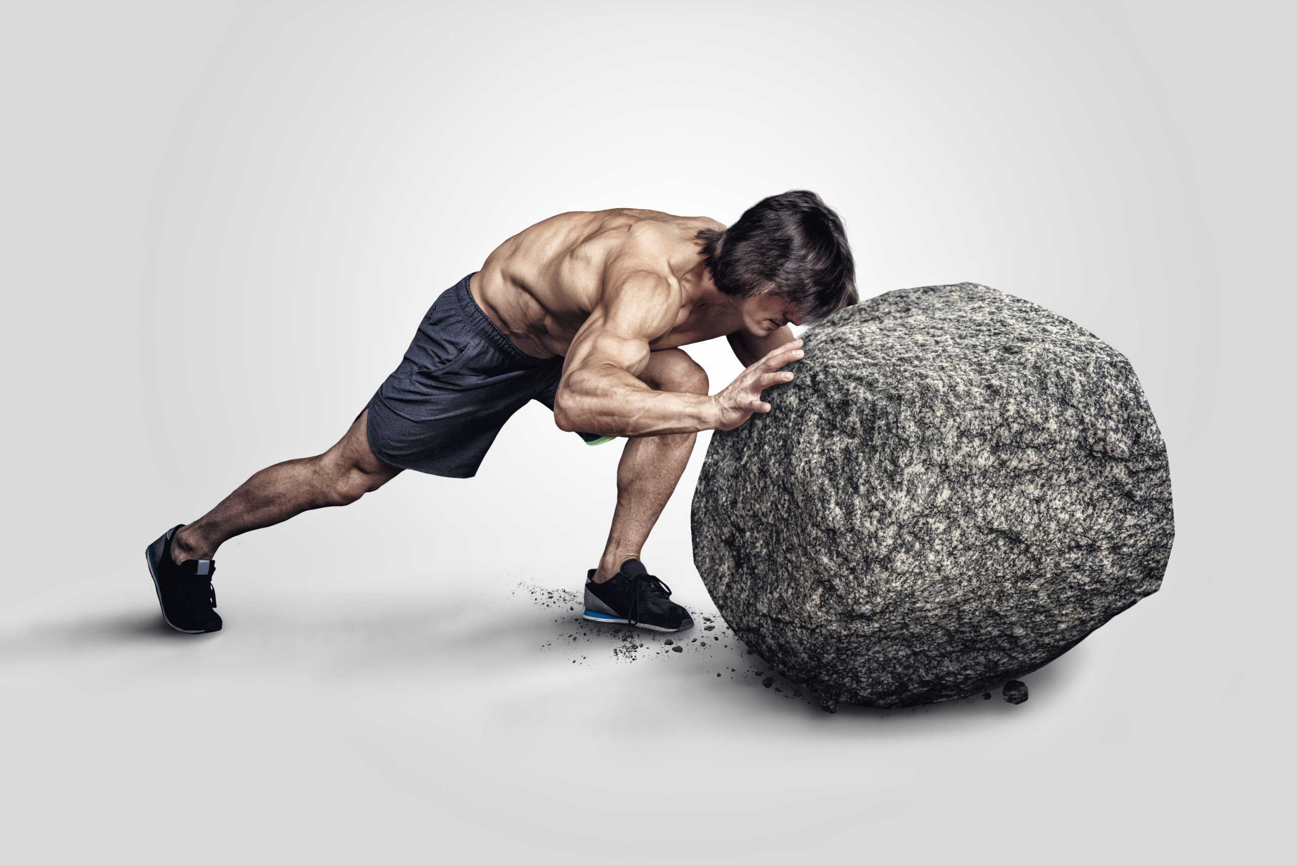 man pushing rock